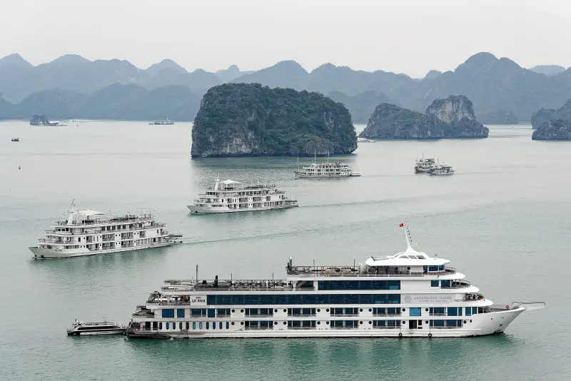 Cruise boats among limestone islands in Ha Long Bay, Vietnam
